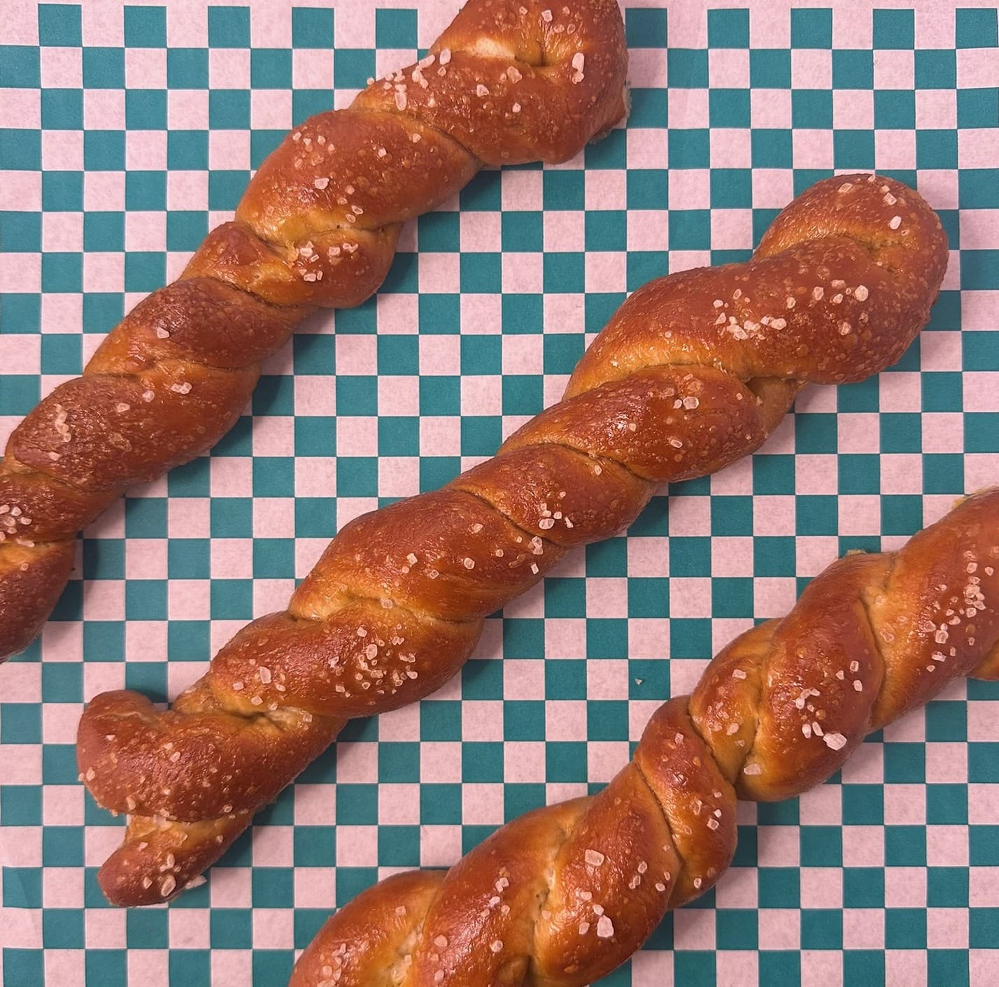 Fresh pretzel sticks on bakery paper